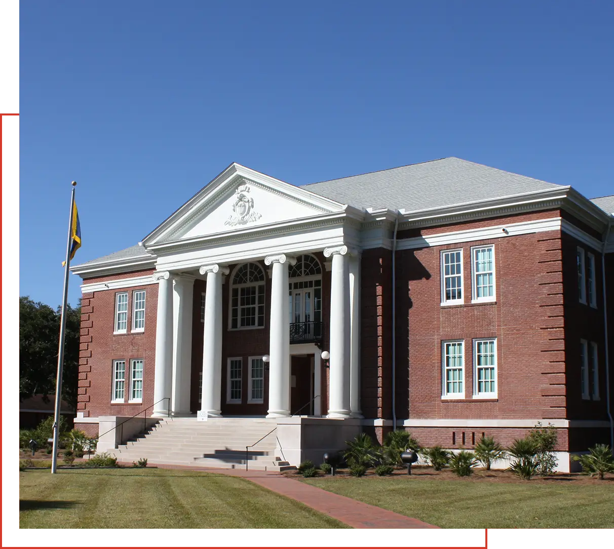 Historic red brick courthouse with white columns