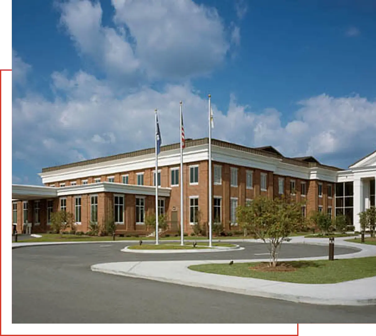 red-brick municipal building with flagpoles